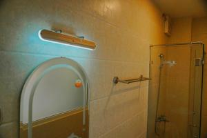 a bathroom with a shower and a glass shower backdoor at Hotel Tường Vy 3 in Da Lat