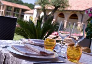 a table with wine glasses and some food on it at Annia Park Hotel Venice Airport in Tessera