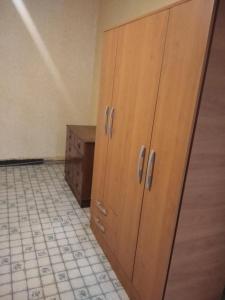 a kitchen with wooden cabinets and a tiled floor at Altos del Almendral in Valparaíso +8 photos
