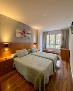 Ένα ή περισσότερα κρεβάτια σε δωμάτιο στο Hostal RIO SELMO