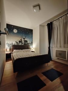 a bedroom with a bed with a deer mural on the wall at Mons Apartments Jahorina in Jahorina