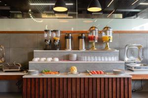 a kitchen with plates of food on a counter at Mazarine Hotels & Resorts LLP in Kalpetta