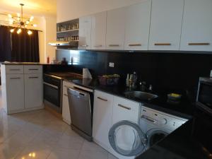 a kitchen with a washing machine and a sink at Hurghada HOME in Hurghada +3 photos