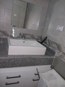 a bathroom with a white sink and a mirror at Hurghada HOME in Hurghada