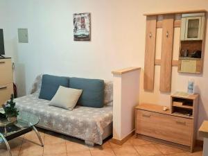 a living room with a couch and a table at APARTMANI DELAS in Pješčana Uvala