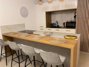 a kitchen with a counter with chairs around it at BLEU AZUR in Fréjus