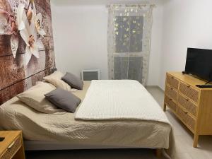 a small bedroom with a bed and a dresser at BLEU AZUR in Fréjus