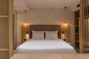 a bedroom with a large white bed with two pillows at Radisson Blu Hotel, Kas in Kaş