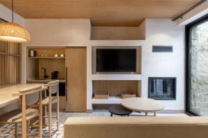 a living room with a table and a tv at Radisson Blu Hotel, Kas in Kaş