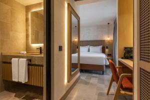 a hotel room with a bed and a bathroom at Radisson Blu Hotel, Kas in Kaş