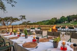 a table set up for a wedding with a fire pit at Muluwa Lodge in White River