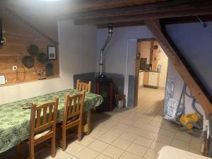a kitchen and dining room with a table and chairs at La grange de Maurines in Maurines