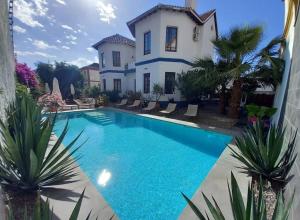 a swimming pool in front of a house at El Cielo Azul in Alora