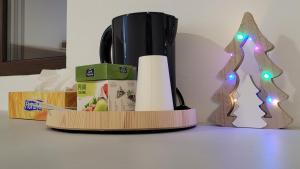 a toilet paper dispenser with a christmas tree on a table at Private Room - Terasa - Gradina in Paşcani