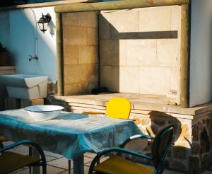 a table with chairs and a bowl on top of it at Casa Vrani in Borgagne