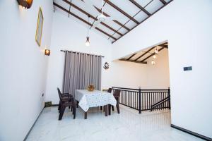a dining room with a table and chairs at Cinnamon View in Batigama