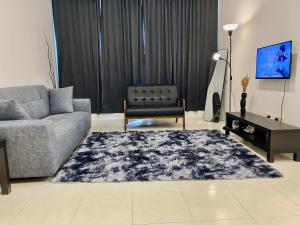a living room with a couch and a chair at Tulis Thooleep Homestay in Chemor