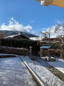 a snow covered driveway with a house in the background at Villa la tourelle in Saint-Gervais-les-Bains