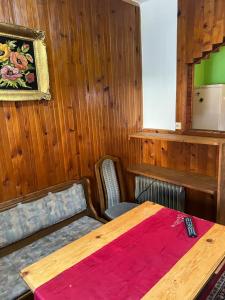 a room with a wooden table with a red blanket at Slobo Velickovic in Prokuplje