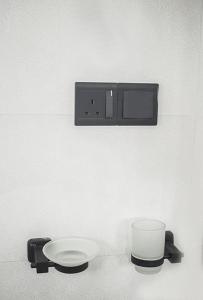 a white toilet with a plate on a wall at Sanasa Villa Weligama in Weligama