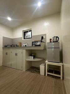 a kitchen with a sink and a refrigerator in it at Caalan Cottage in El Nido +4 photos