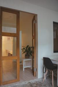 a door leading into a room with a table and a chair at Caalan Cottage in El Nido