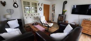 a living room with two couches and a tv at Chaletwohnung Alpenglück in Burgberg