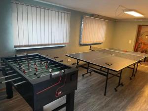 two ping pong tables sitting in a room with at Ferienwohnung Jolie in Sankt Oswald