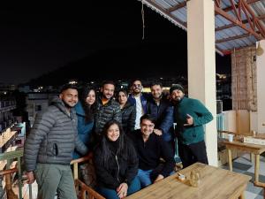 a group of people posing for a picture on a table at GreenDay Escapes Rishikesh in Rishīkesh