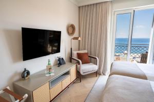 a hotel room with a bed and a television at Amadria Park Grand Hotel 4 Opatijska Cvijeta in Opatija