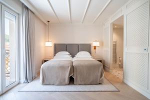 a bedroom with two beds with white sheets at Amadria Park Grand Hotel 4 Opatijska Cvijeta in Opatija