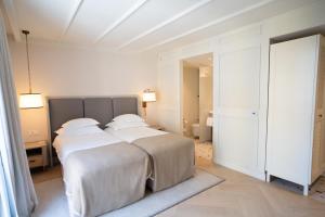 a white bedroom with two beds with white sheets at Amadria Park Grand Hotel 4 Opatijska Cvijeta in Opatija