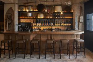 a bar with stools in a room at Ishigakijima Hotel Cucule in Ishigaki Island