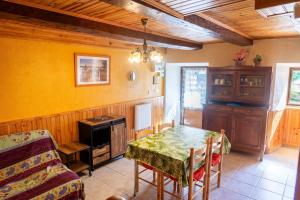a dining room with a table and a stove at Le castel in Laval-du-Tarn