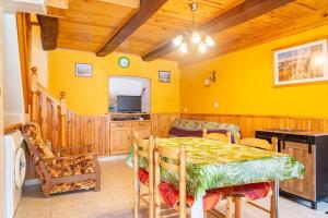 a dining room with a table and a tv at Le castel in Laval-du-Tarn