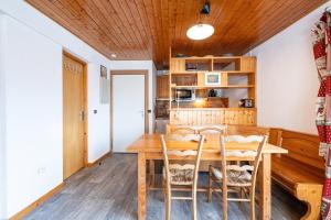 a dining room with a wooden table and chairs at Appartement 22 - 5 personnes in Les Allues +15 photos