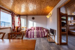 a living room with a bed and a table at Appartement 22 - 5 personnes in Les Allues