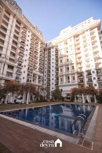 a large apartment building with a swimming pool in front of it at Elegant Edge 3BHK Apartment in Pātan