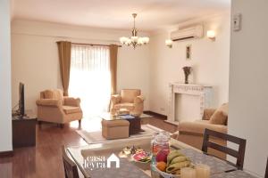 a living room with a table with a bowl of fruit at Elegant Edge 3BHK Apartment in Pātan