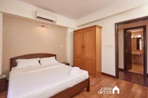 a bedroom with a bed and a wooden cabinet at Elegant Edge 3BHK Apartment in Pātan +15 photos