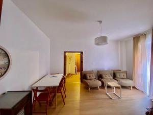 a living room with a table and chairs and a clock at U cafè in Monte San Giacomo