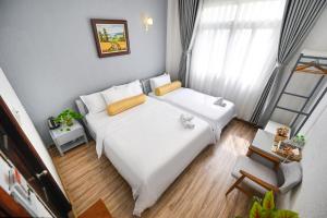 Postel nebo postele na pokoji v ubytování Amory Hotel Saigon Center
