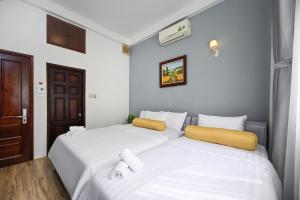 Postel nebo postele na pokoji v ubytování Amory Hotel Saigon Center