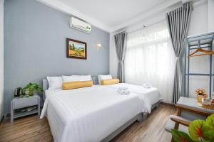 Postel nebo postele na pokoji v ubytování Amory Hotel Saigon Center