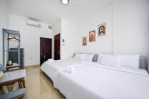 Postel nebo postele na pokoji v ubytování Amory Hotel Saigon Center
