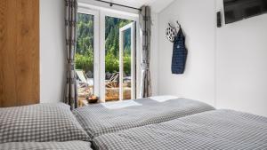 a bedroom with a bed and a sliding glass door at Wendelstein Mountain Camp in Fischbachau