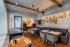 a restaurant with tables and chairs and a bar at Hotel Monastère Maastricht in Maastricht