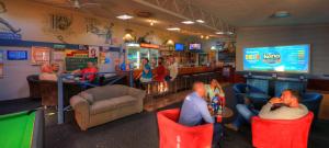 a group of people sitting in chairs in a bar at Port Arthur Motor Inn in Port Arthur