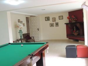 a living room with a pool table in it at Hotel Monte Carlo in Campos do Jordão