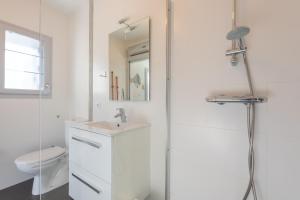 a white bathroom with a sink and a toilet at Chalet de Sers in Sers
